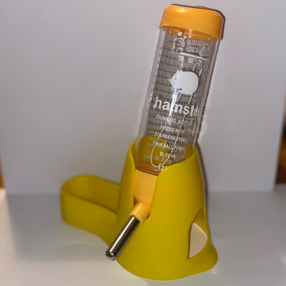 A yellow 3-In-1, (water bottle, feeding dish, and small hideout).